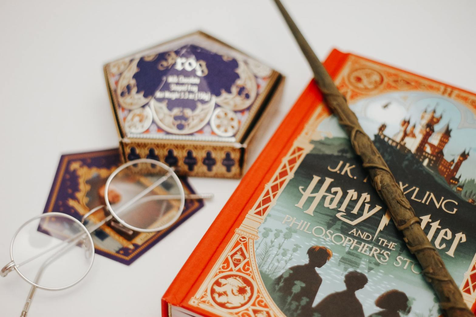 Harry Potter book, glasses, wand, and chocolate