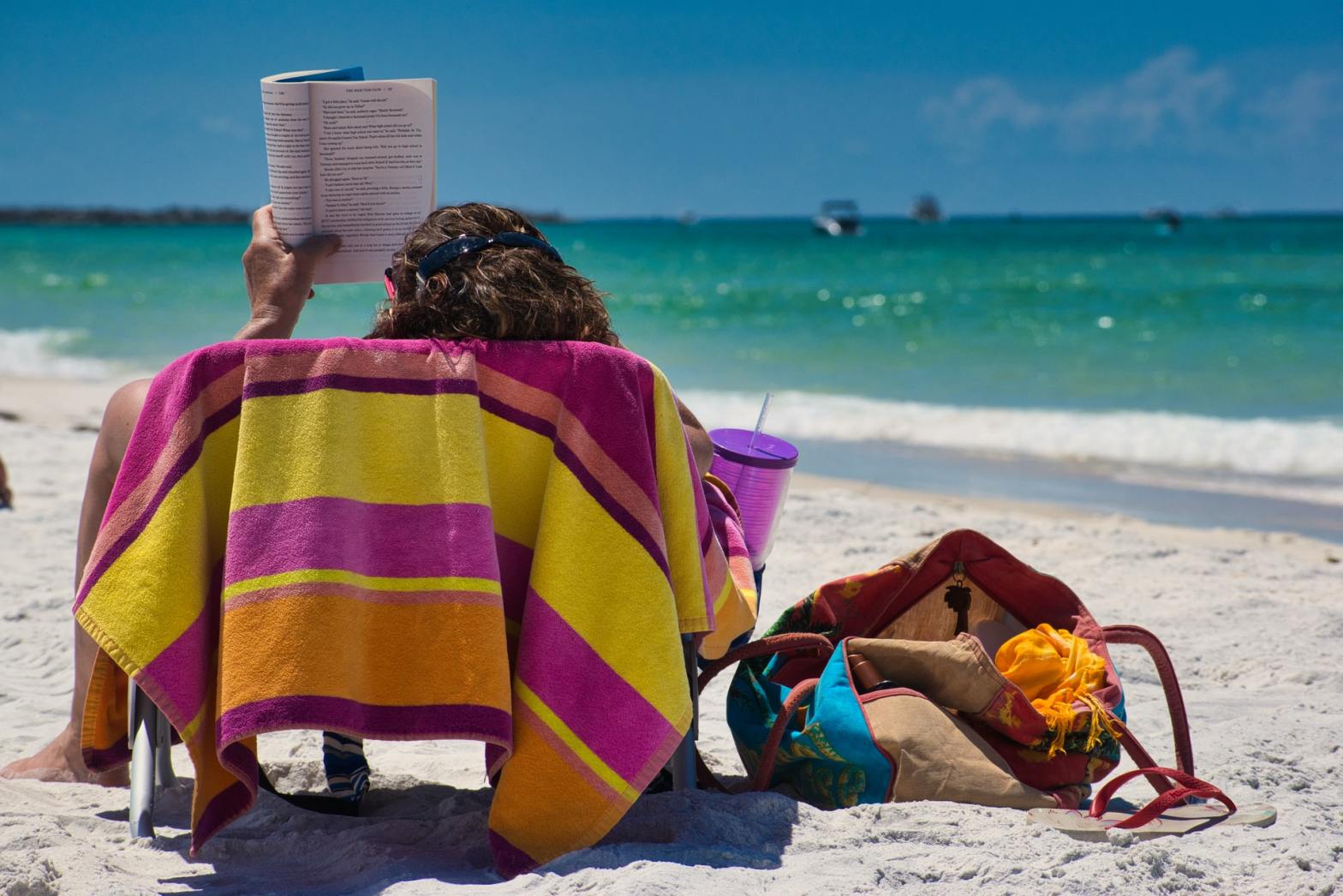 A woman reading by the beach
