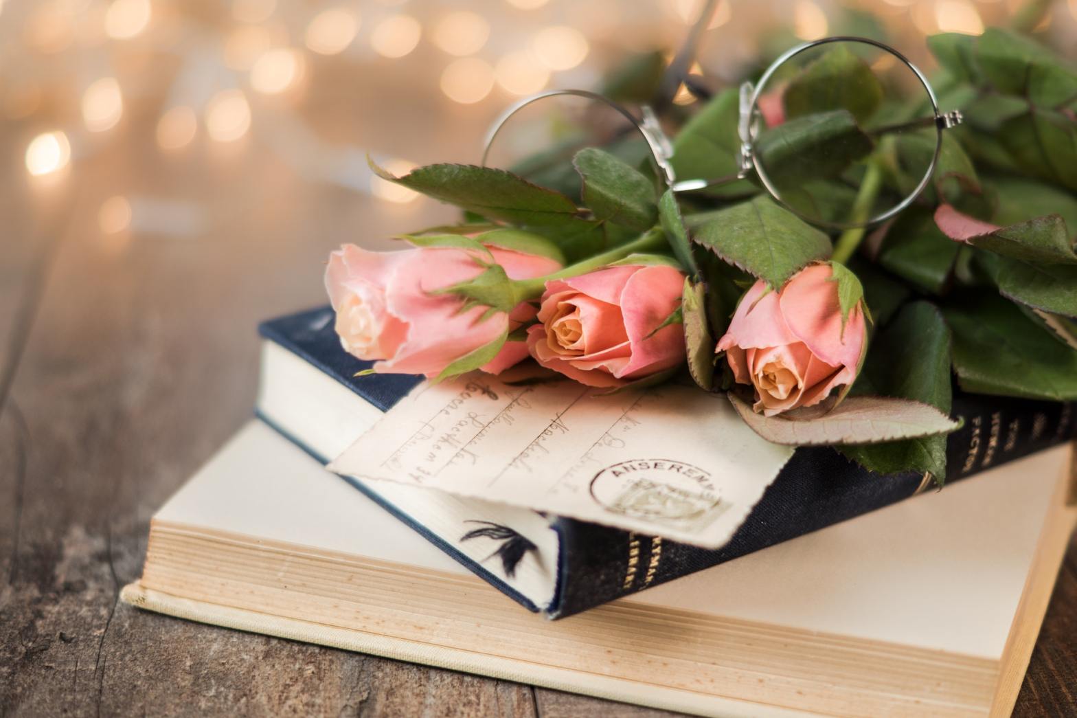 Flowers and eyeglasses on top of a book