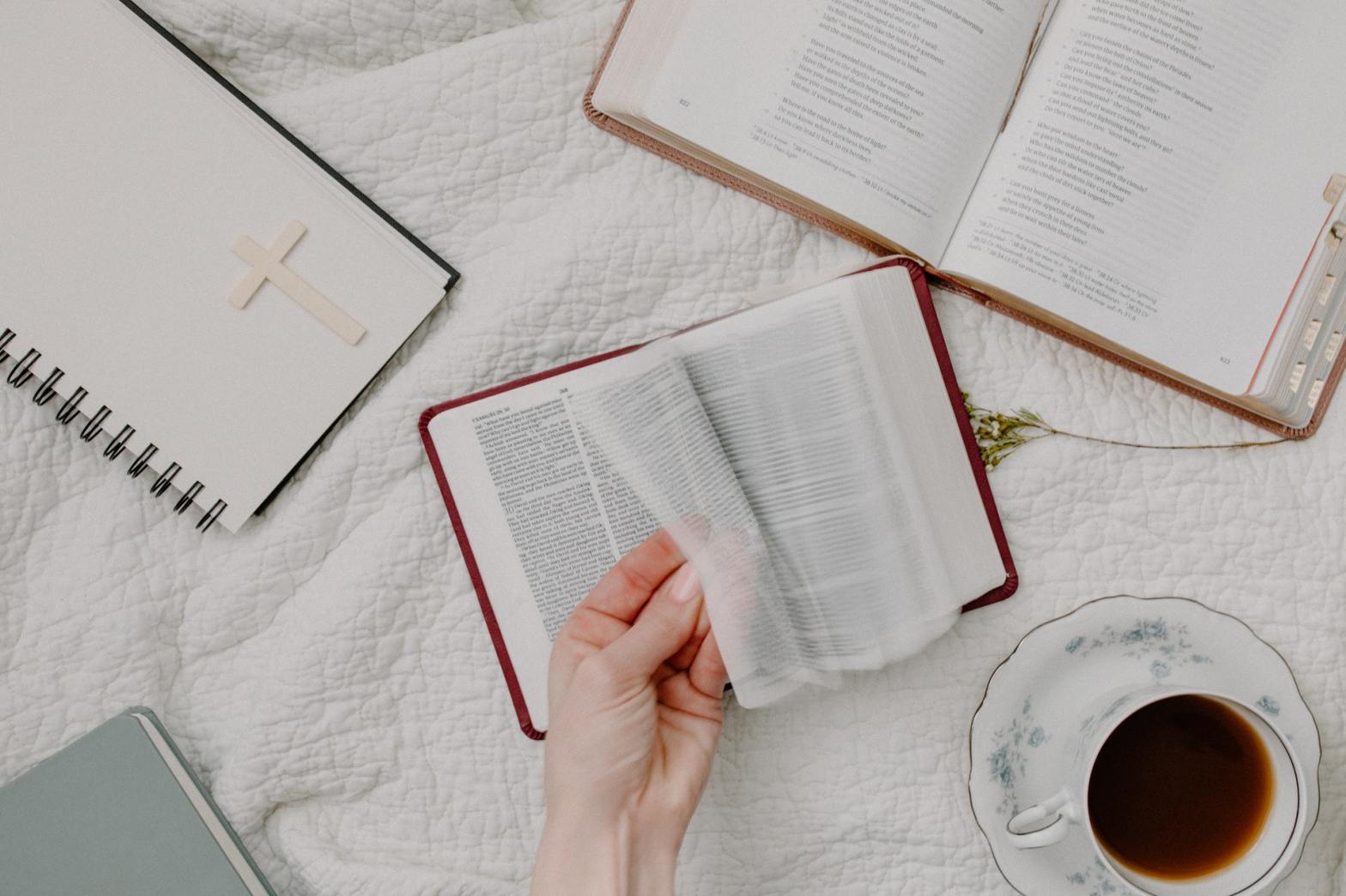 A person's hand flipping a page from a book