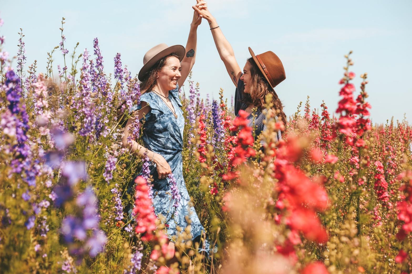 Girls dancing in the middle of a flower field