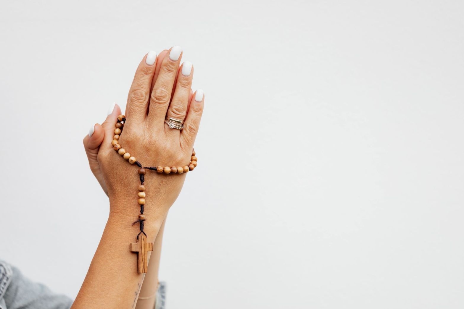 Hand Holding Rosary Beads