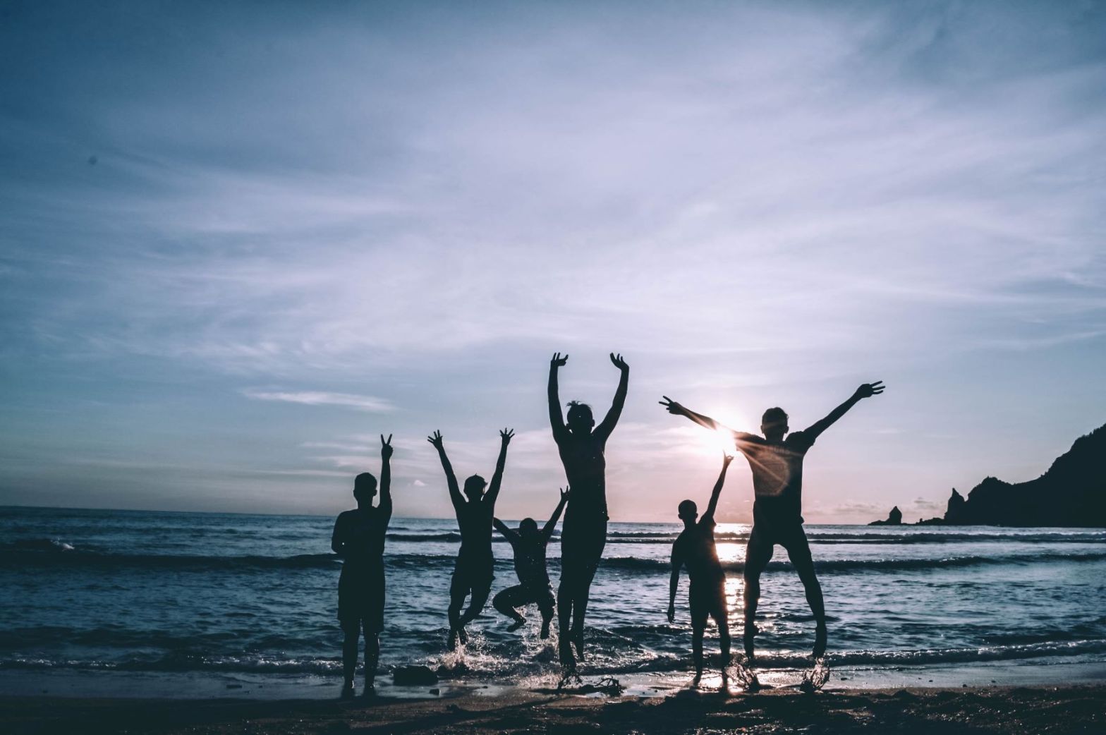 Group of people having fun on a beach shore.
