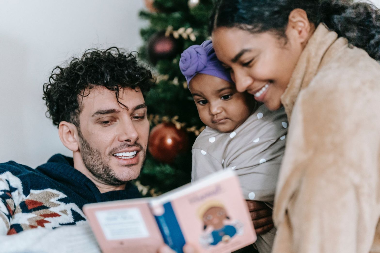 A couple reads to their young child