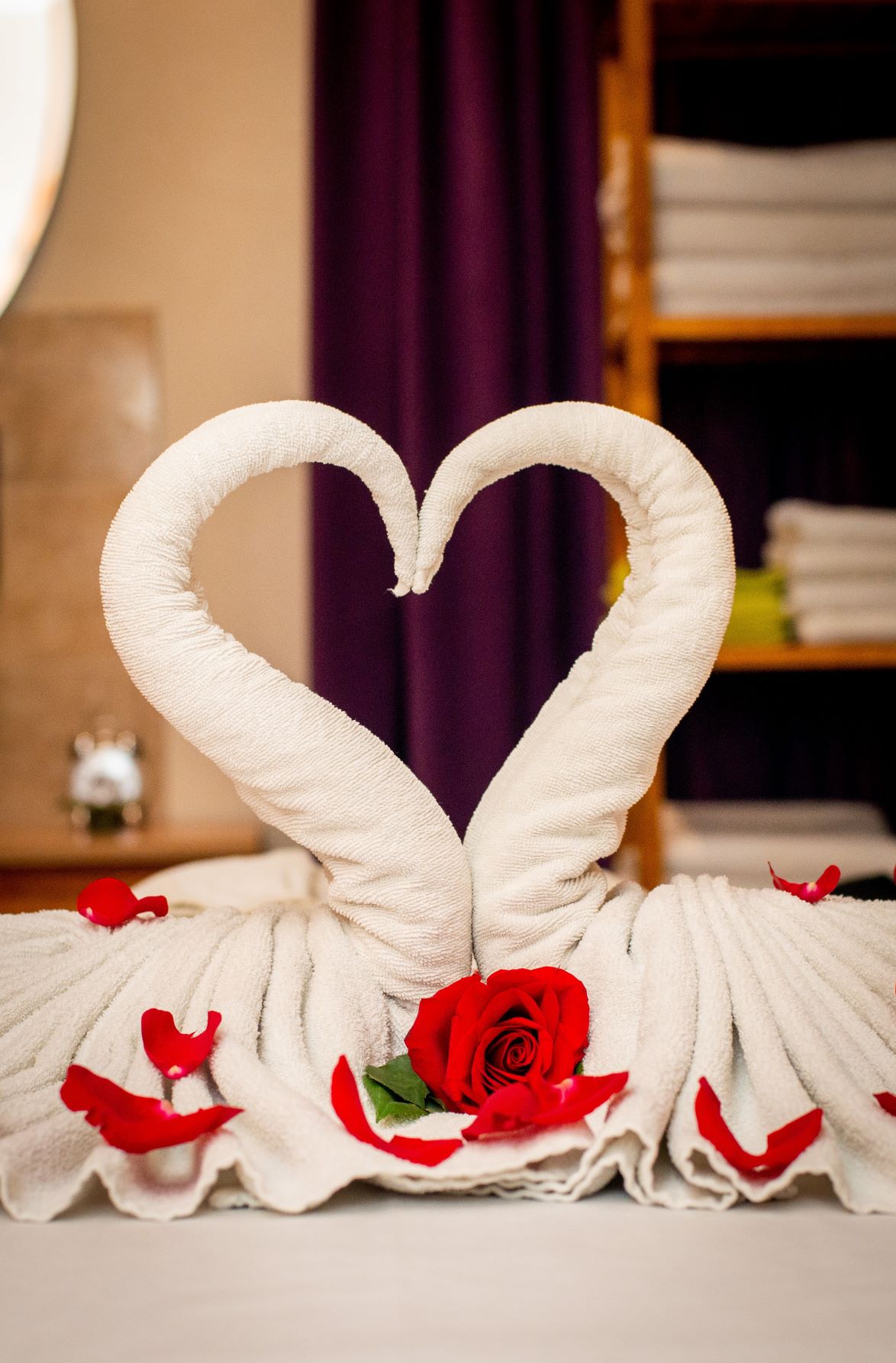 swan towels forming a heart